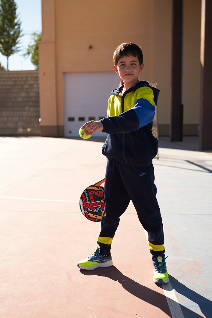 Boy wearing Joma's Part sweat-suit in the school playground.